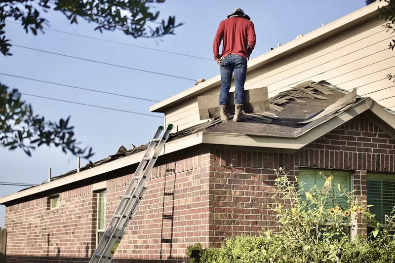 Professional roofer working on a residential roof in North Forestville
